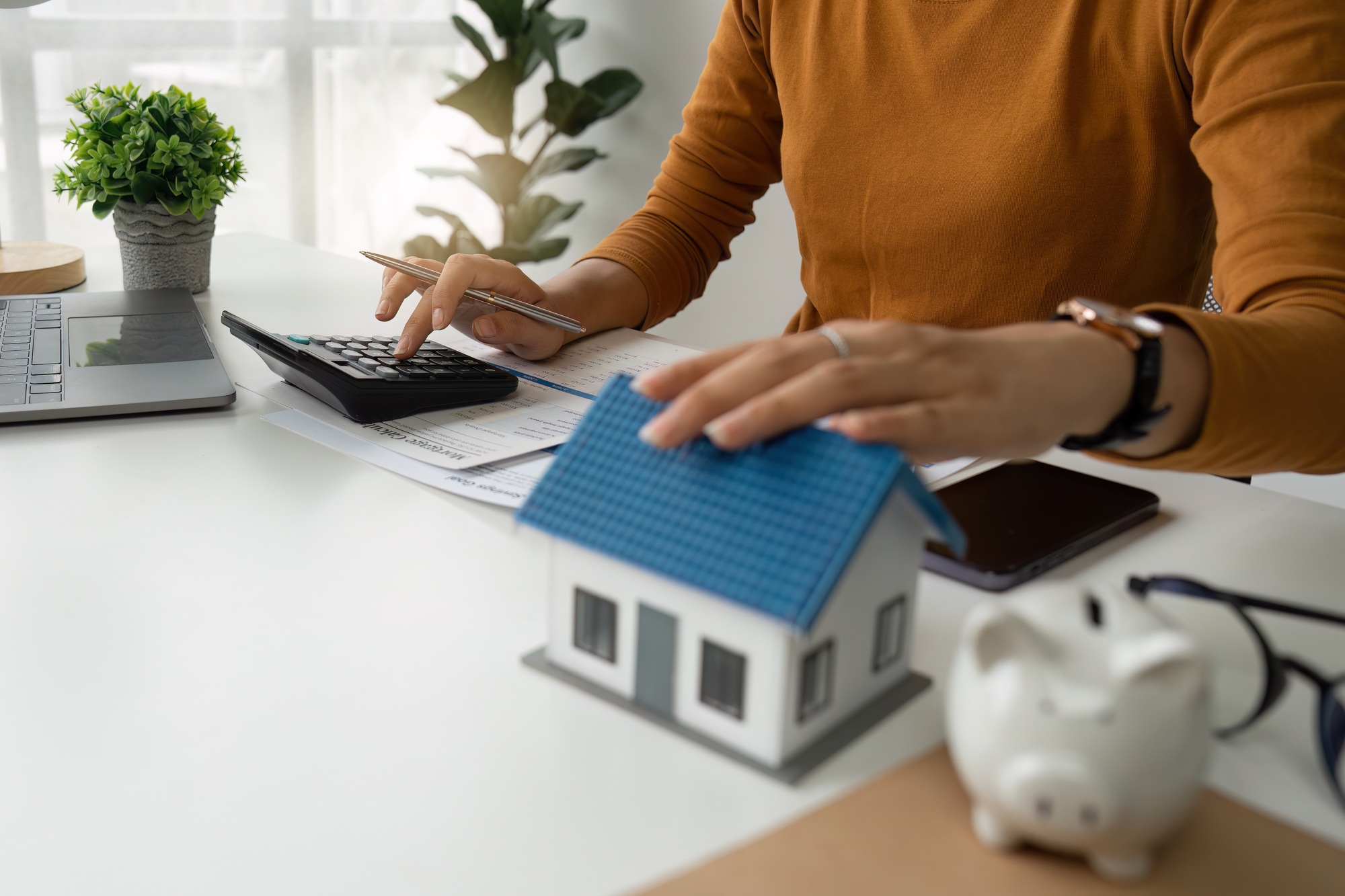 Asian accounting professional calculating household bills, reviewing and analyzing household bills
